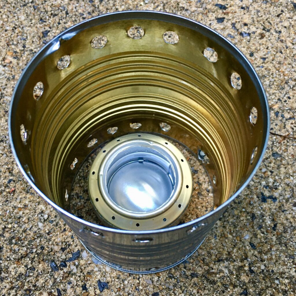DIY denatured alcohol stove and a pot support made from a food can.