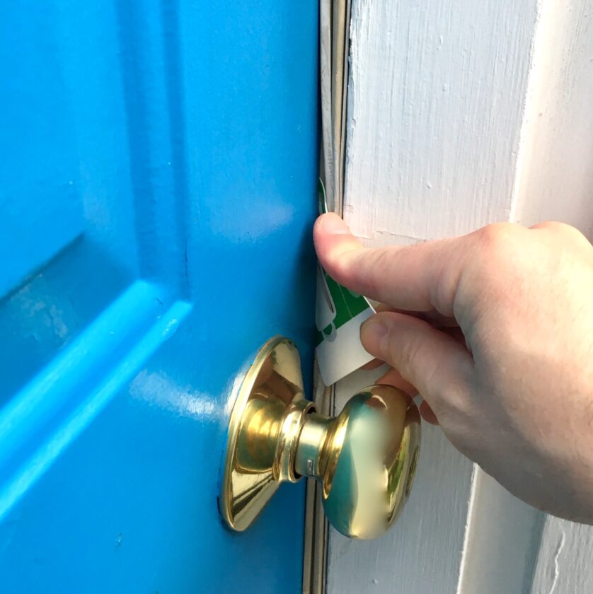 Starbucks gift card being used to shim a door.