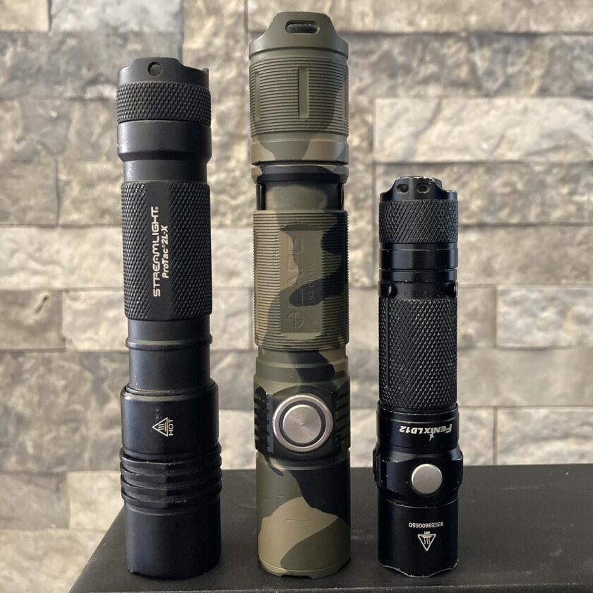 The LAPG F7 compared for size with the Streamlight ProTac and Fenix LD12.